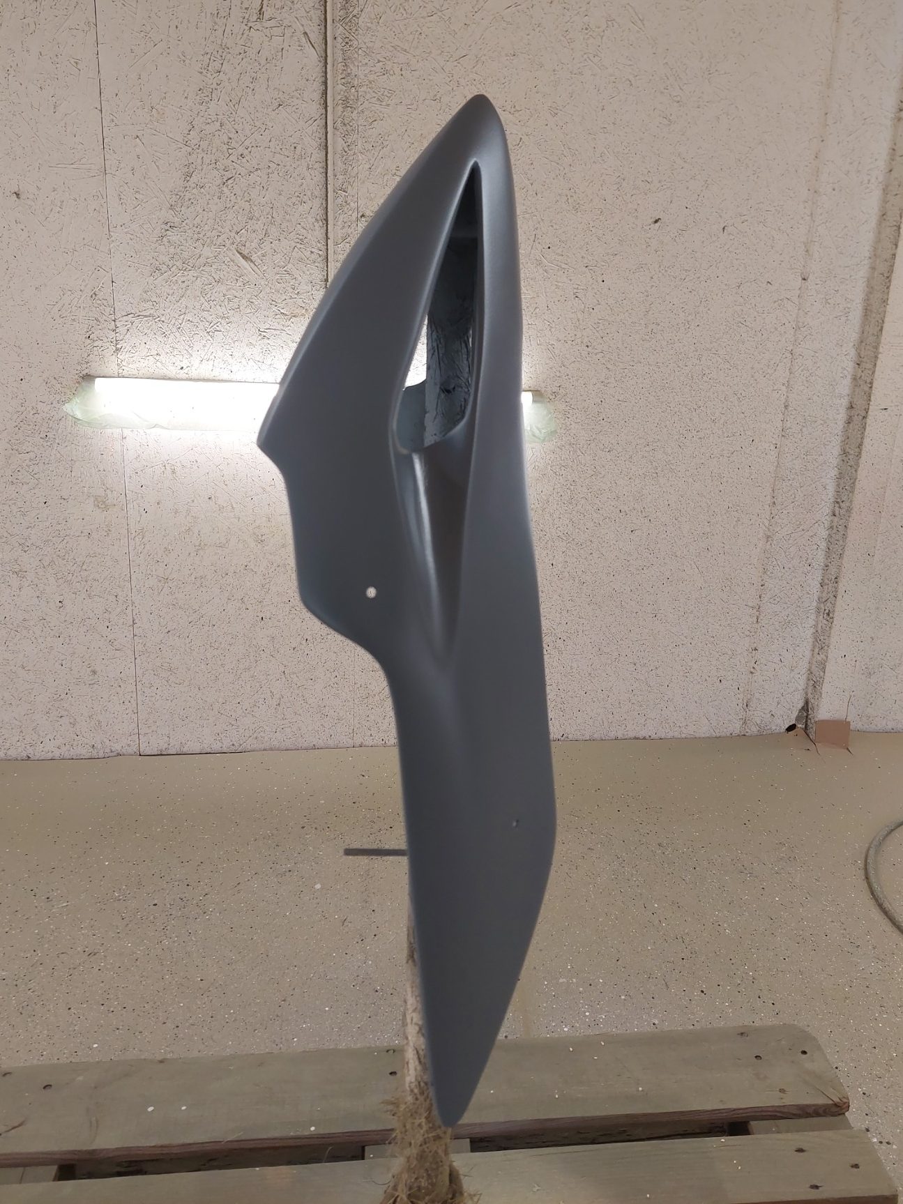 carénage arrière pour moto Pièce de carrosserie grise, profil aérodynamique, fond neutre.